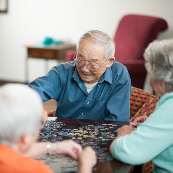 seniors building a puzzle